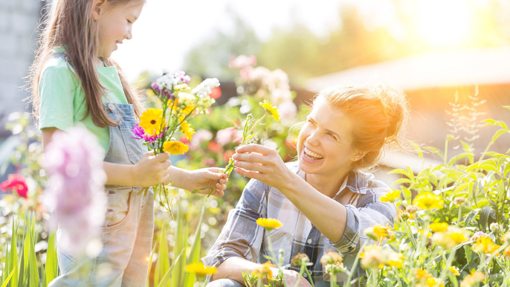 a photo of spring flowers: mother and daughter making a bouquet