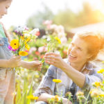 a photo of spring flowers: mother and daughter making a bouquet