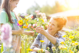 a photo of spring flowers: mother and daughter making a bouquet