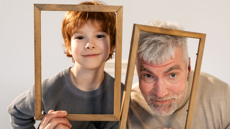 Photo of a grandfather and his grandson acting silly