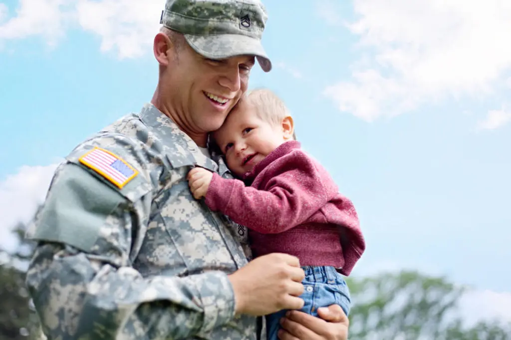 Photo of military father holding son