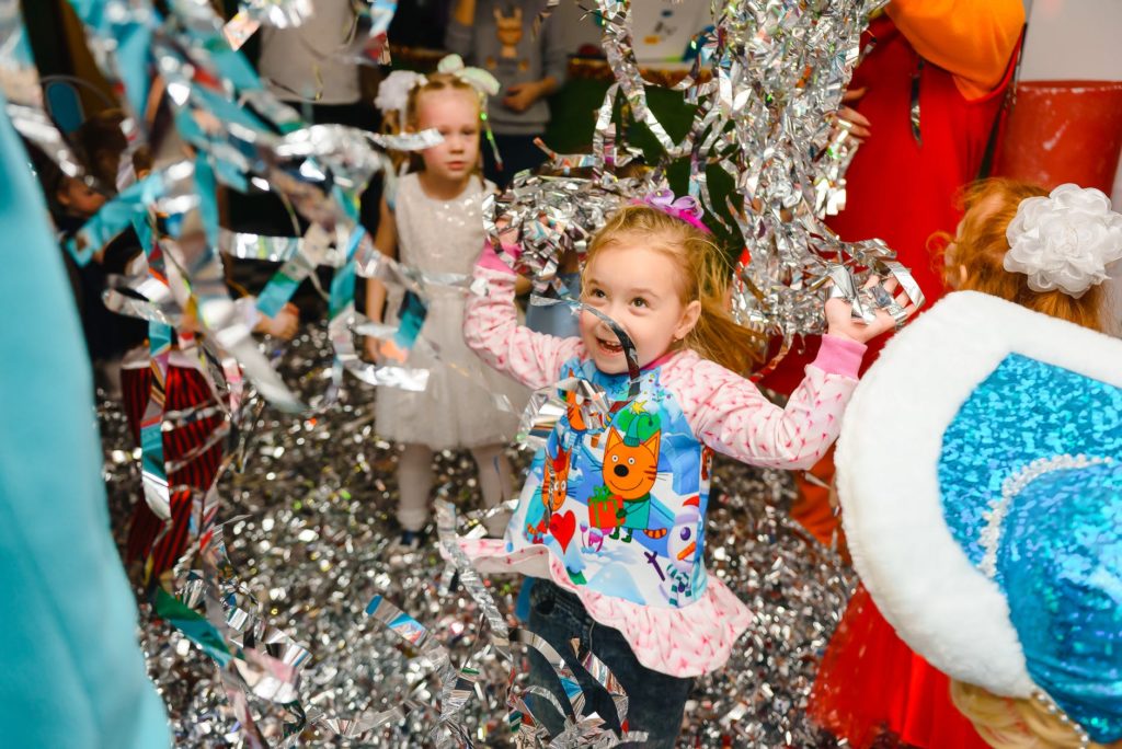 Photo of a girl playing with birthday decorations