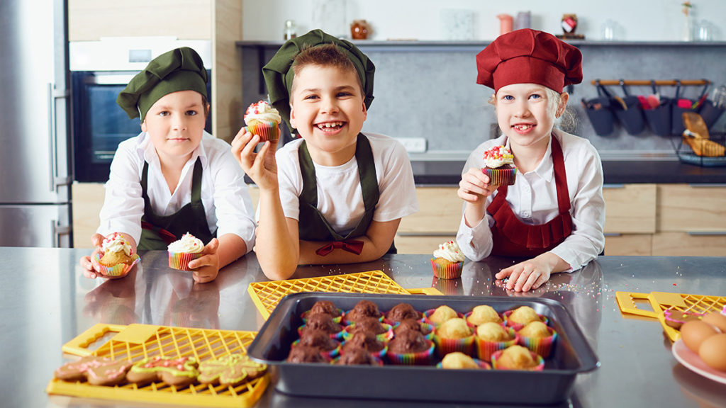 Photo of kids baking cupcakes