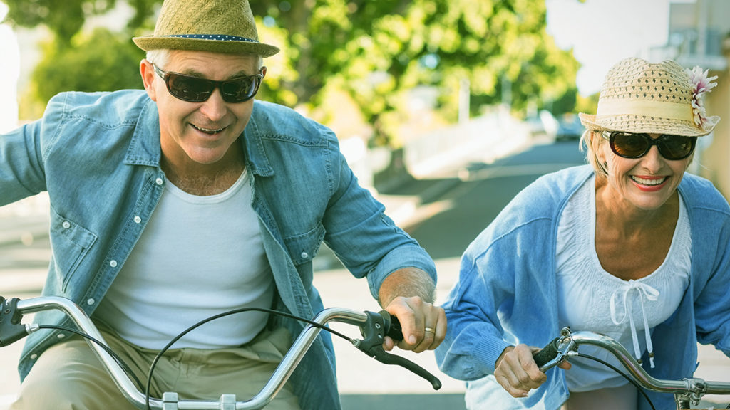 Photo of older couple riding bikes