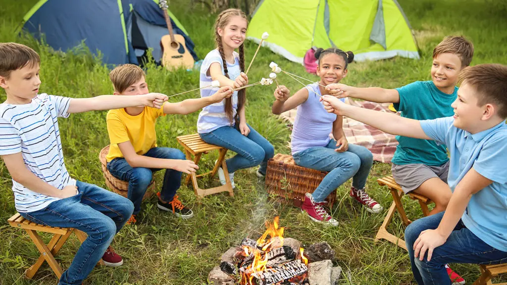Photo of kids roasting marshmallows at a fall birthday party