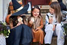 Photo of kids eating cookies at a costume party