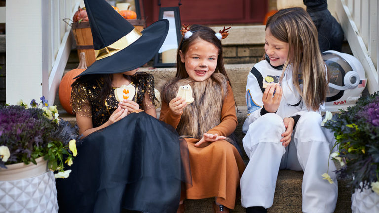 Photo of kids eating cookies at a costume party