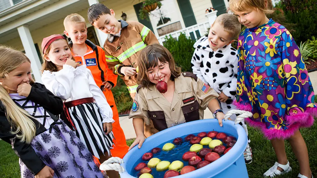 Photo of kids bobbing for apples at a fall birthday party