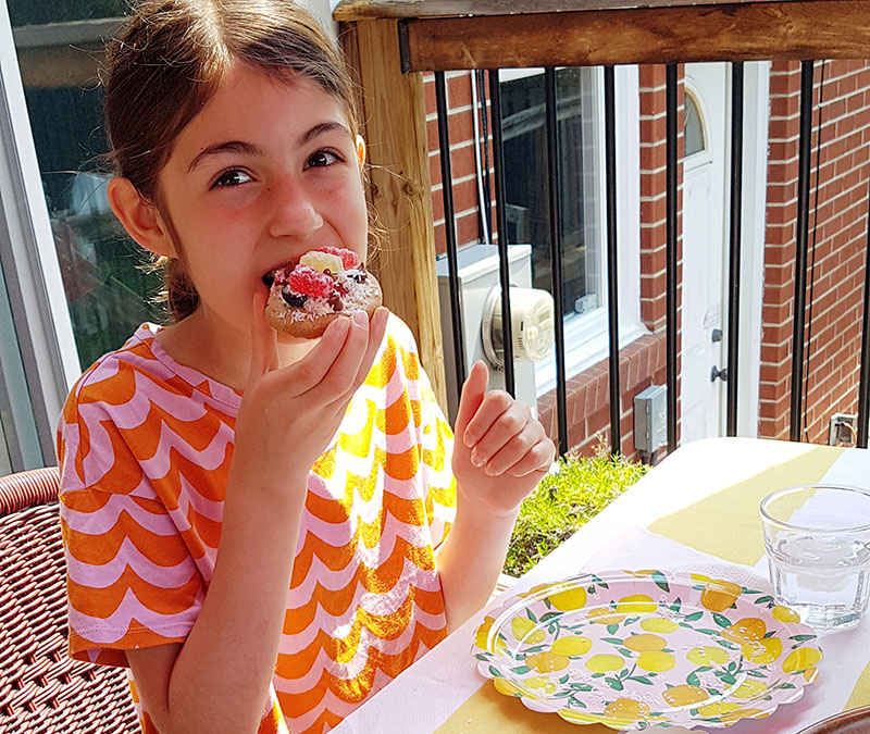 Photo of girl eating a mini chocolate chip cookie pizza