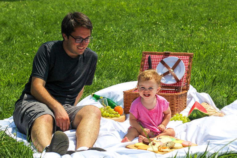 Photo of father and daughter on a picnic, crossing an item off their summer bucket list