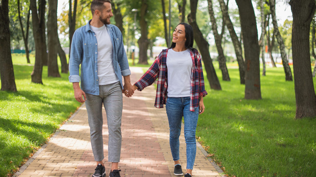 Photo of a man and a woman walking together