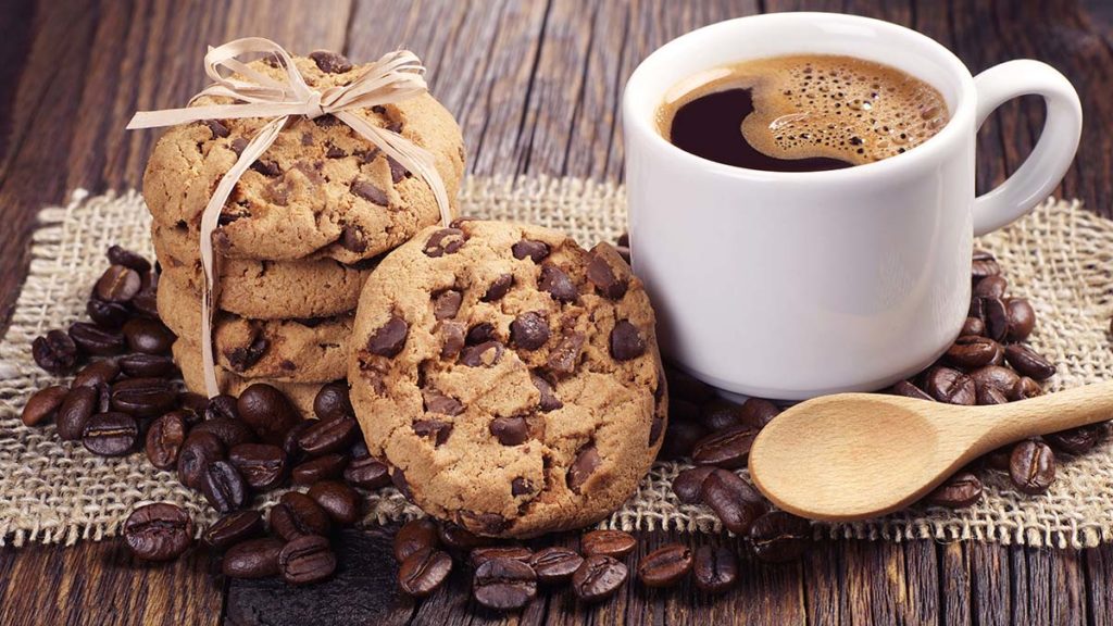 Photo of a cup of coffee with chocolate chip cookies