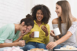 Photo of a group of friends drinking coffee and eating cookies