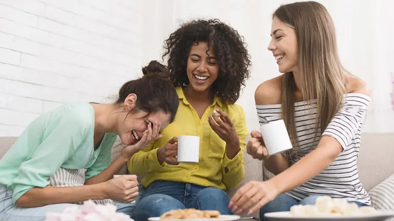 Photo of a group of friends drinking coffee and eating cookies