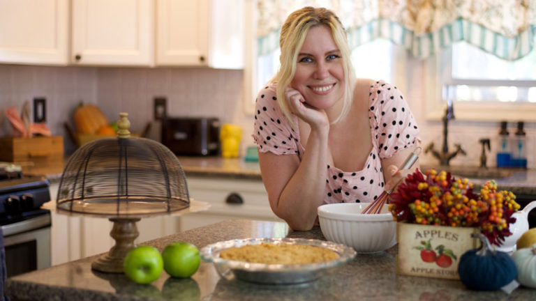 Photo of Jackie Rupp in the kitchen baking a pie