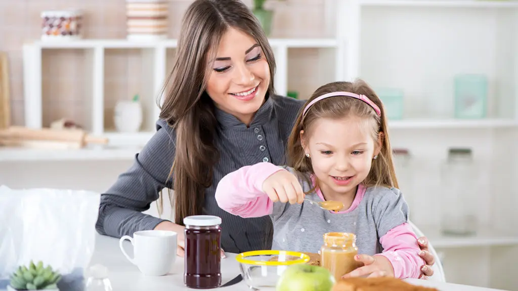 Photo of mother and daughter making a peanut butter and jelly sandwich