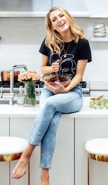 Photo of Sarah Crawford, founder of Broma Bakery, mixing cookie batter