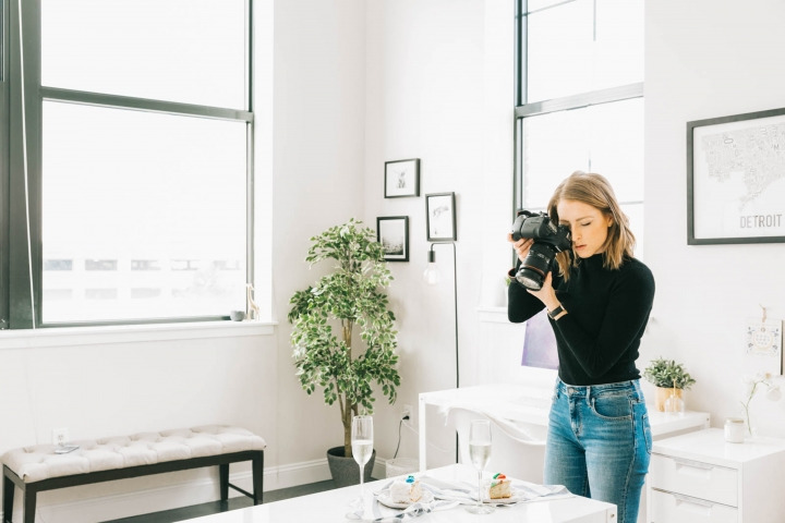 Photo of Sarah Crawford, founder of Broma Bakery, taking a picture of food