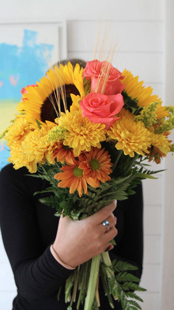 Photo of a woman holding a bouquet of flowers