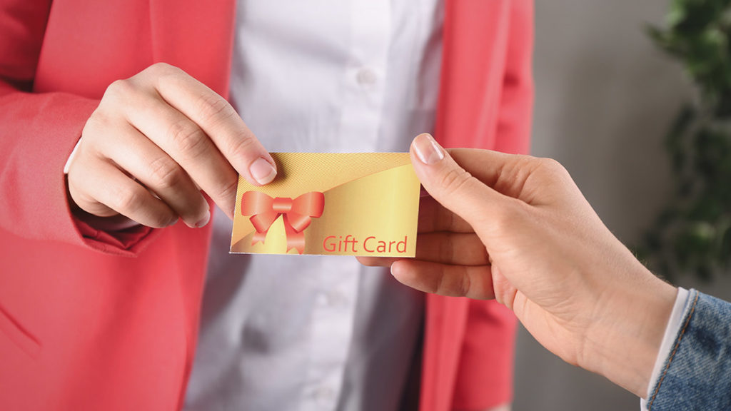 Photo of a person exchanging a gift card