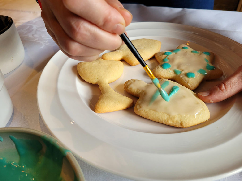 Photo of brushing frosting on a Hanukkah cookie