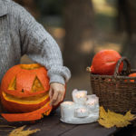 Photo of a woman carving a pumpkin