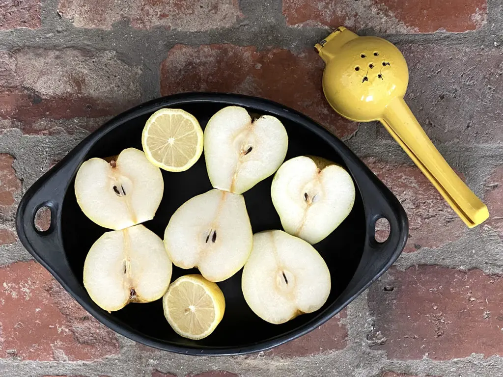 Photo of pears cut in half with a lemon squeezer