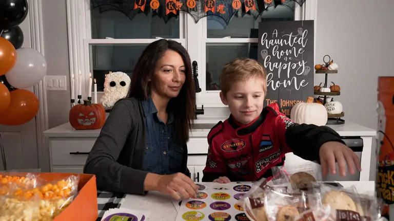 Photo of mother and son making boo bags together