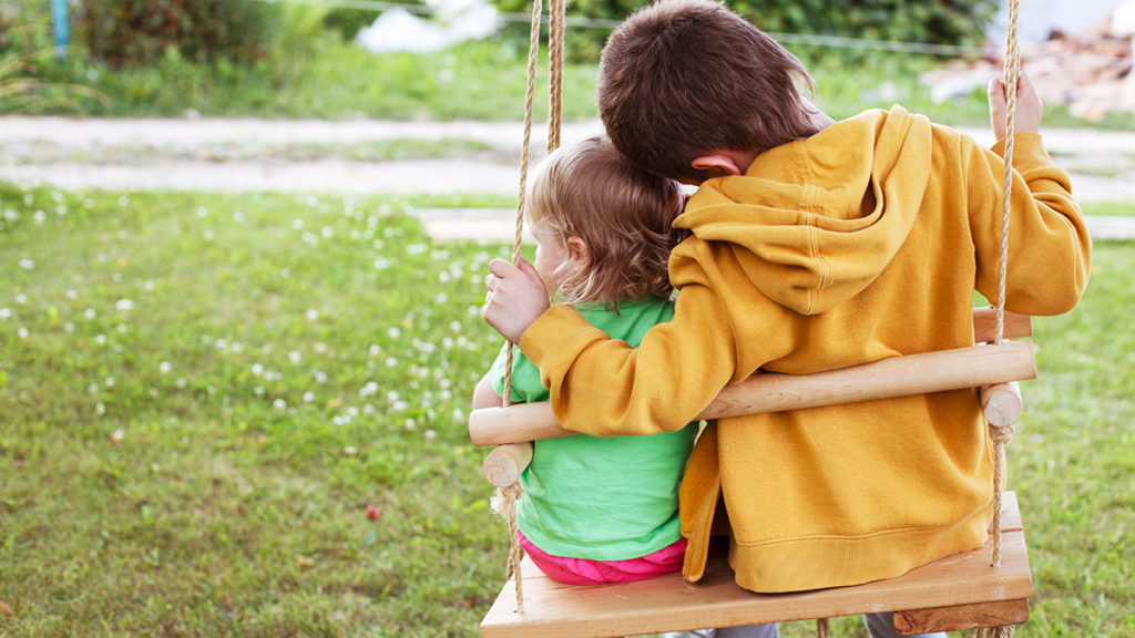 Photo of siblings being kind to each other