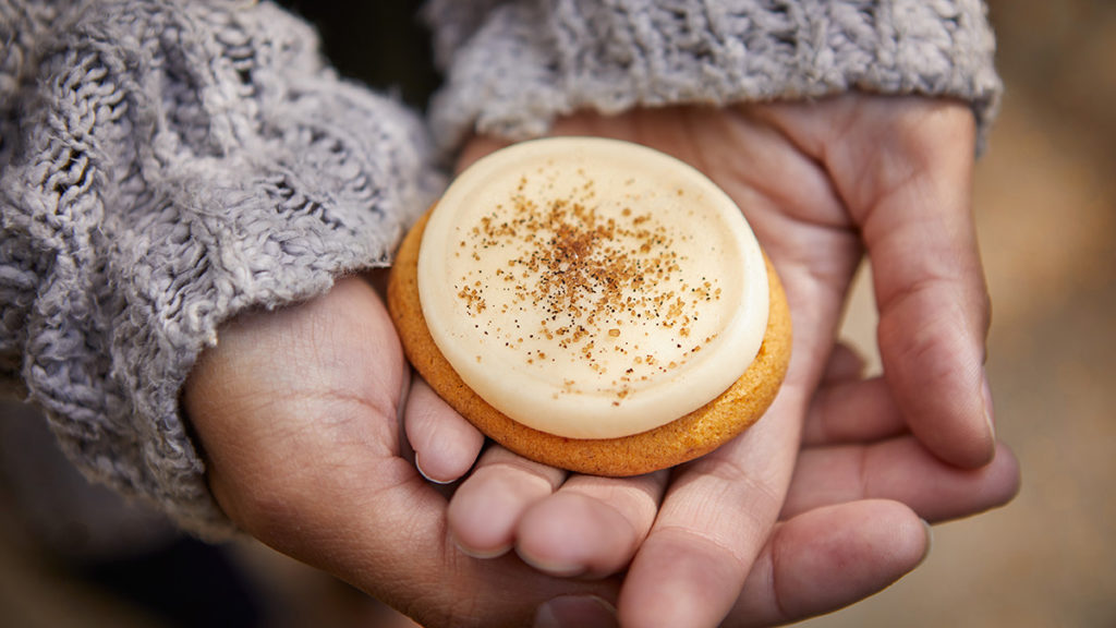 Photo of a fall pumpkin cookie with buttercream frosting