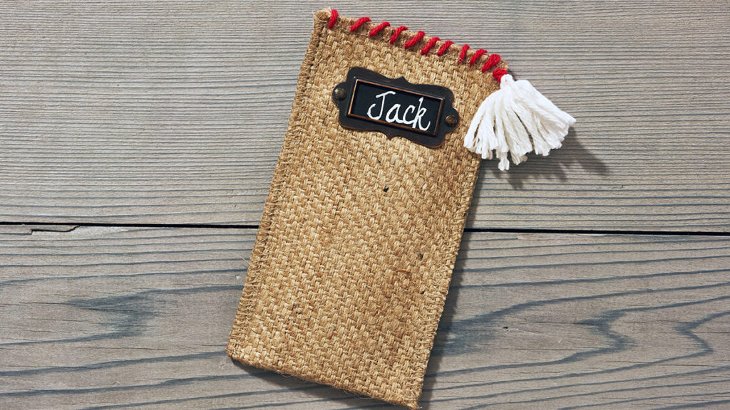 Photo of burlap cutlery holder with pom-pom