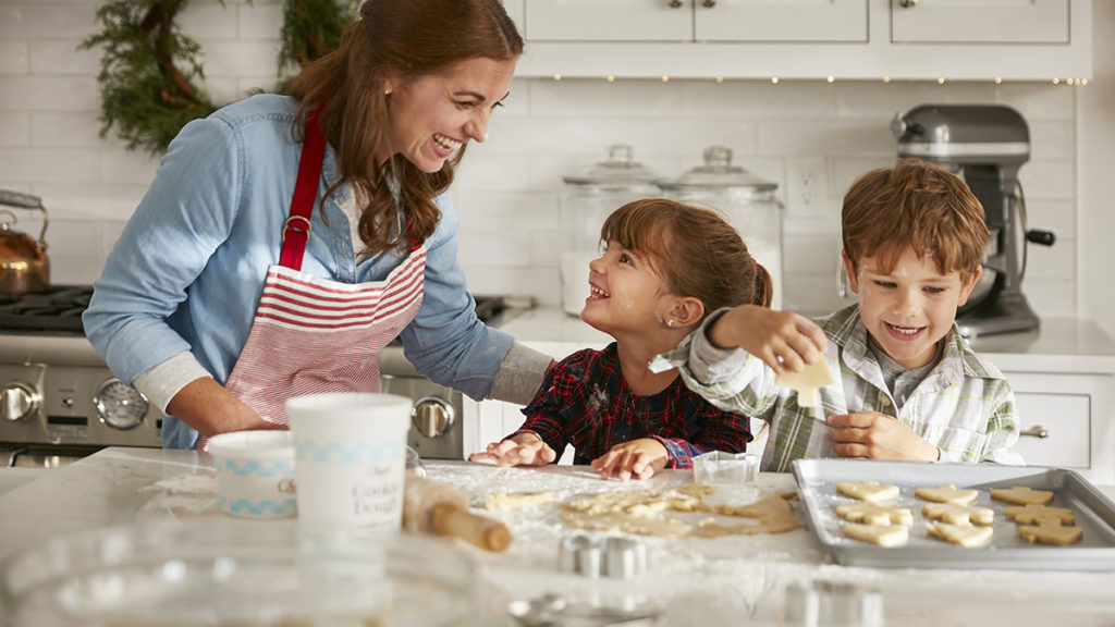 Photo of mom and kids making holiday cookies