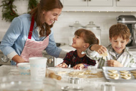 Photo of mom and kids making holiday cookies