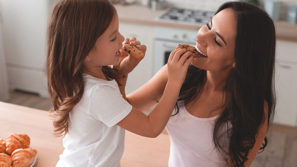 Photo of mother and daughter eating cookies on National Cookie Day