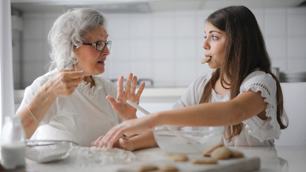 Photo of woman baking cookies with grandmother on National Cookie Day