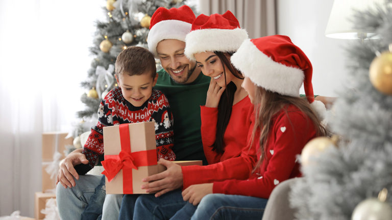 Photo of family opening up Christmas gifts