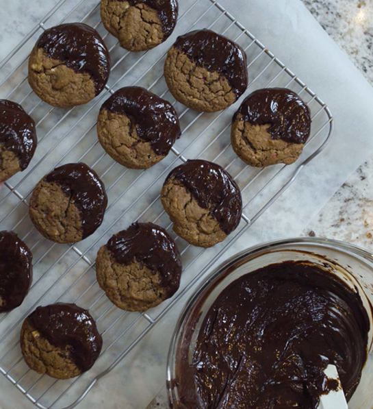 Cookie types with peppermint cookies dipped in chocolate on a tray.