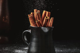 facts about cinnamon. Mug filled with cinnamon sticks.