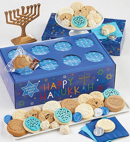 Hanukkah traditions with a box of Hanukkah cookies and a small menorah.