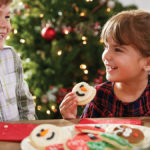 Photo of kids eating christmas cookies