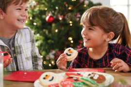 Photo of kids eating christmas cookies