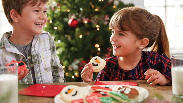 Photo of kids eating christmas cookies