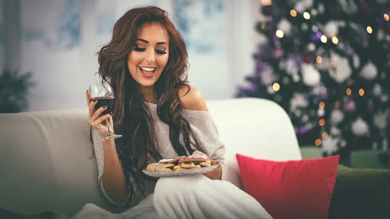 Photo of woman drinking wine and eating cookies