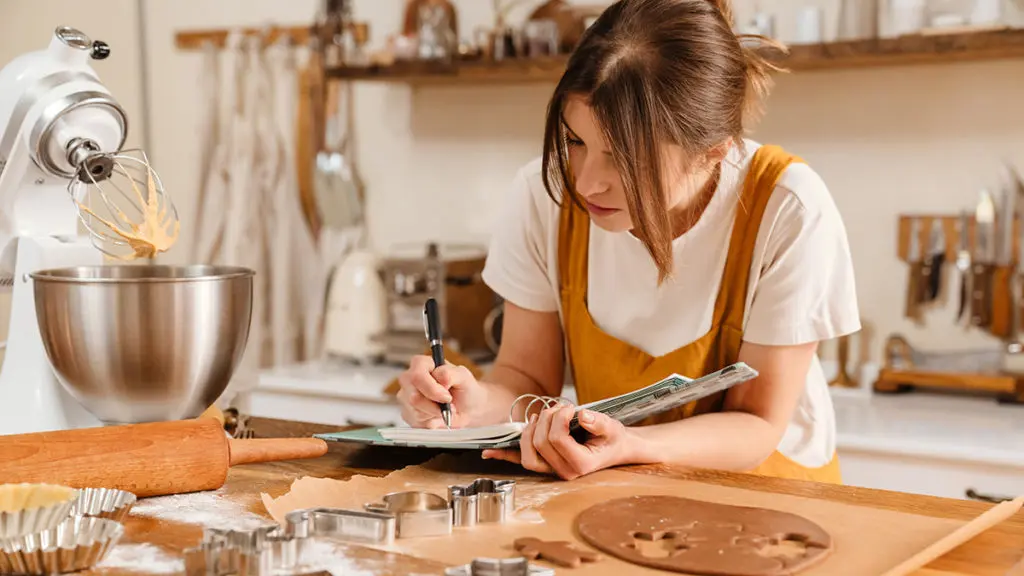 Photo of woman writing out a cookie recipe