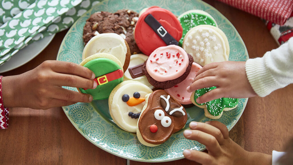 History of Christmas cookies with a plate of decorated cookies.