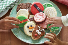 History of Christmas cookies with a plate of decorated cookies.