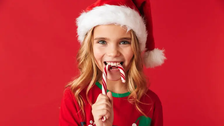 history of peppermint girl in santa hat eating candy cane