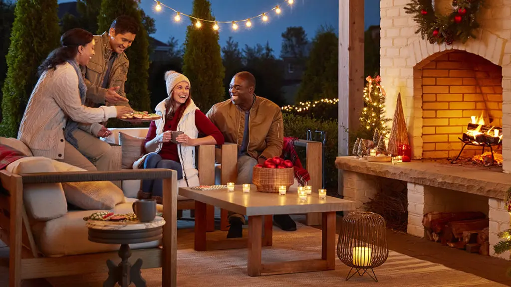 winter gifts with two couples hanging in a backyard by a fireplace. 