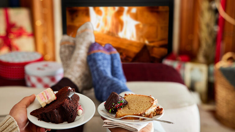 winter gifts couple's feet warming by a fireplace.