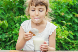 food nostalgia: girl dipping cookies in milk
